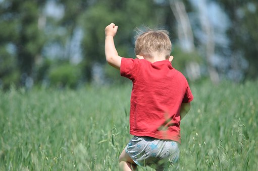 kid running in field