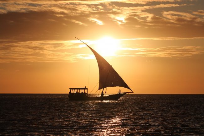 Yacht sailing in sunset