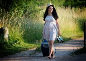woman pulling suitcase